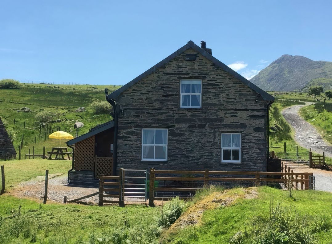 A house with windows and a pathway at Ty Llugwy in Capel Curig near Betws-Y-Coed