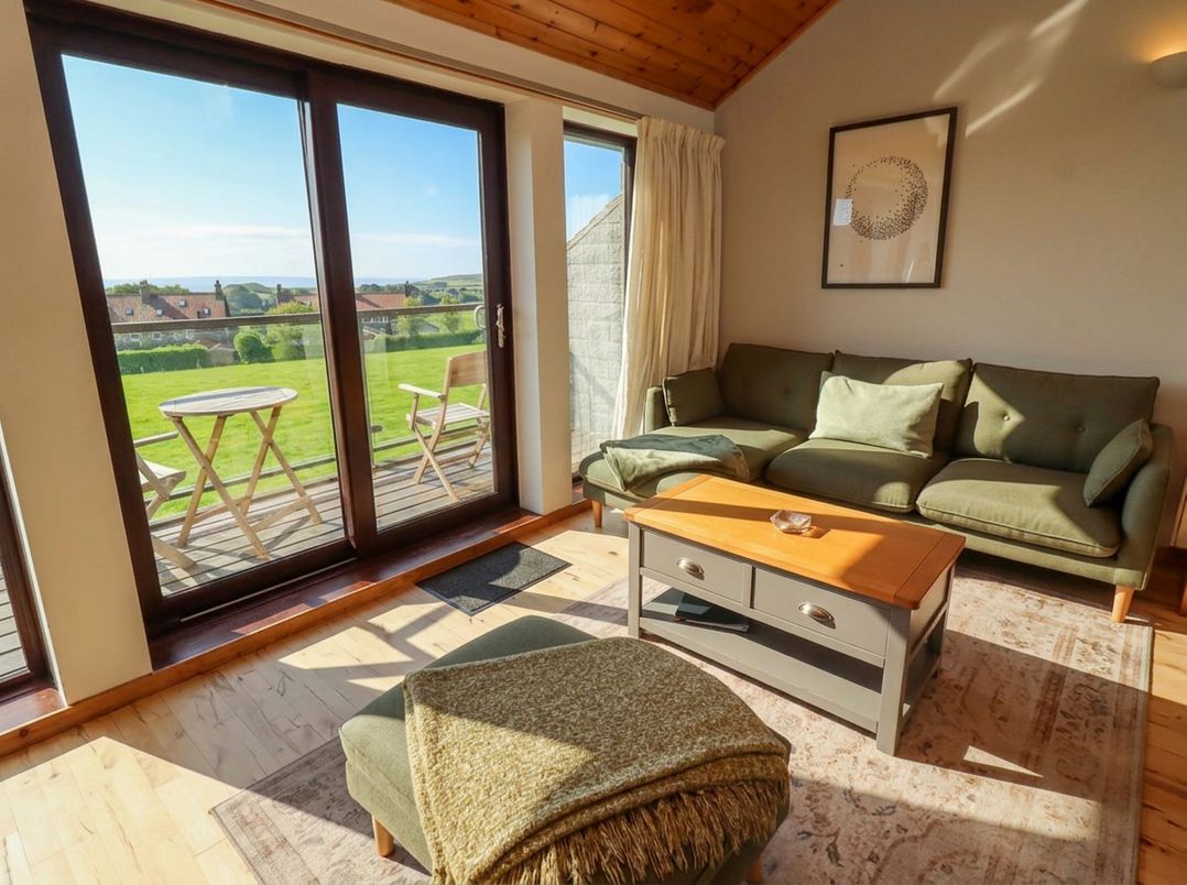 A living room with a sofa and coffee table at Links View in Embleton