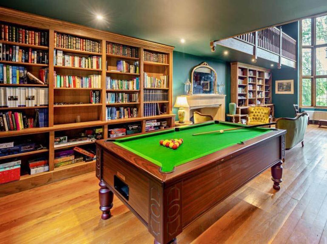 A snug room with a pool table and bookshelves at Luxurious 5 Bedroom House in Cookham near Marlow
