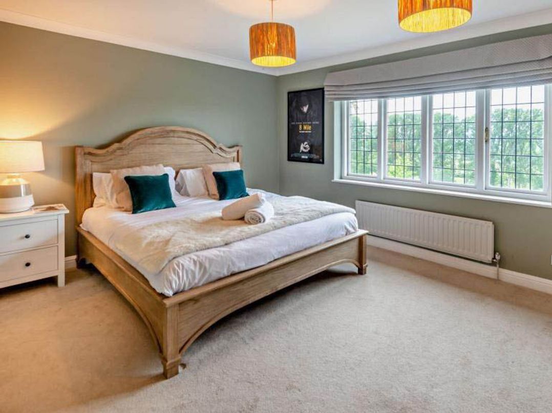 A bedroom with a bed and nightstand at Luxurious 5 Bedroom House in Cookham near Marlow