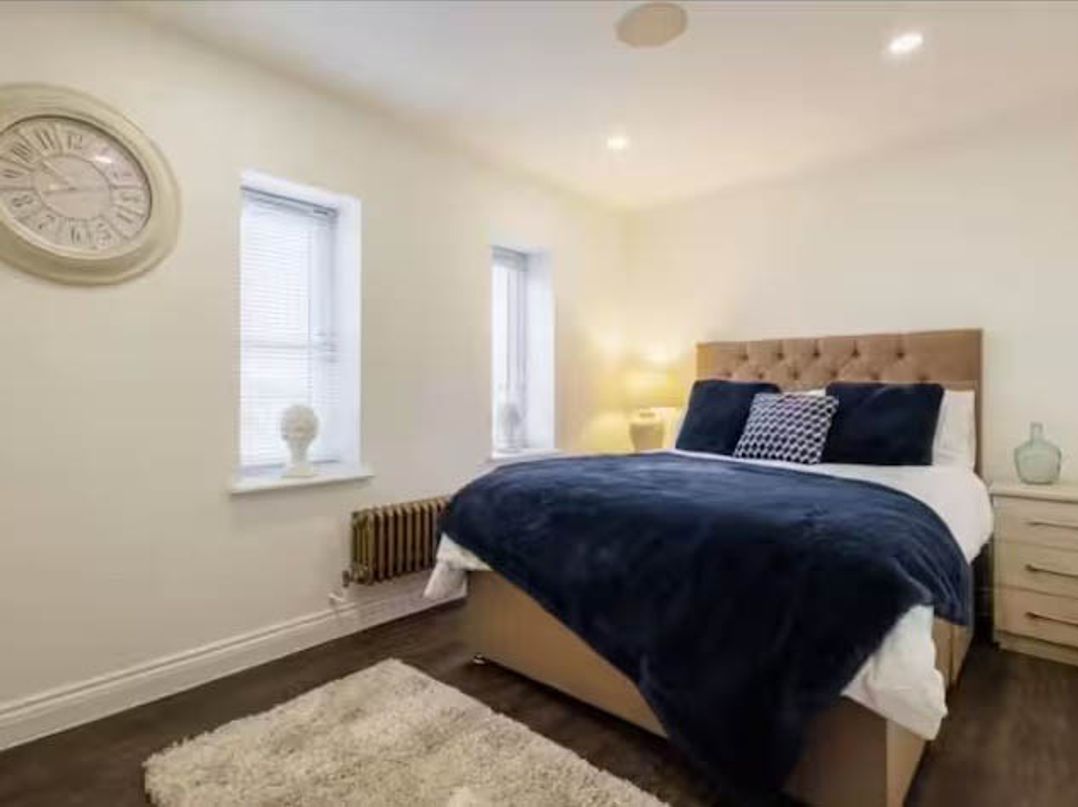 A bedroom with a bed and nightstand at Hot tub BBQ Garden Parking Sleeps 8 Worcester