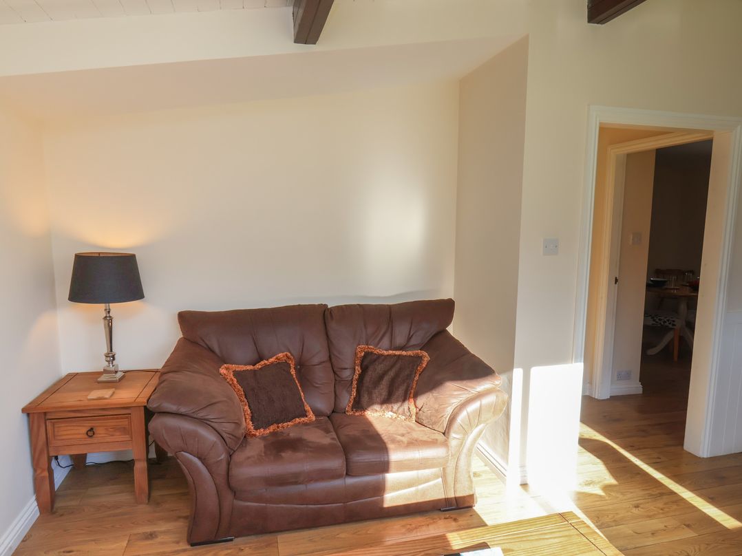A living room with a sofa and lamp at Foxglove Lodge Saltburn-By-The-Sea