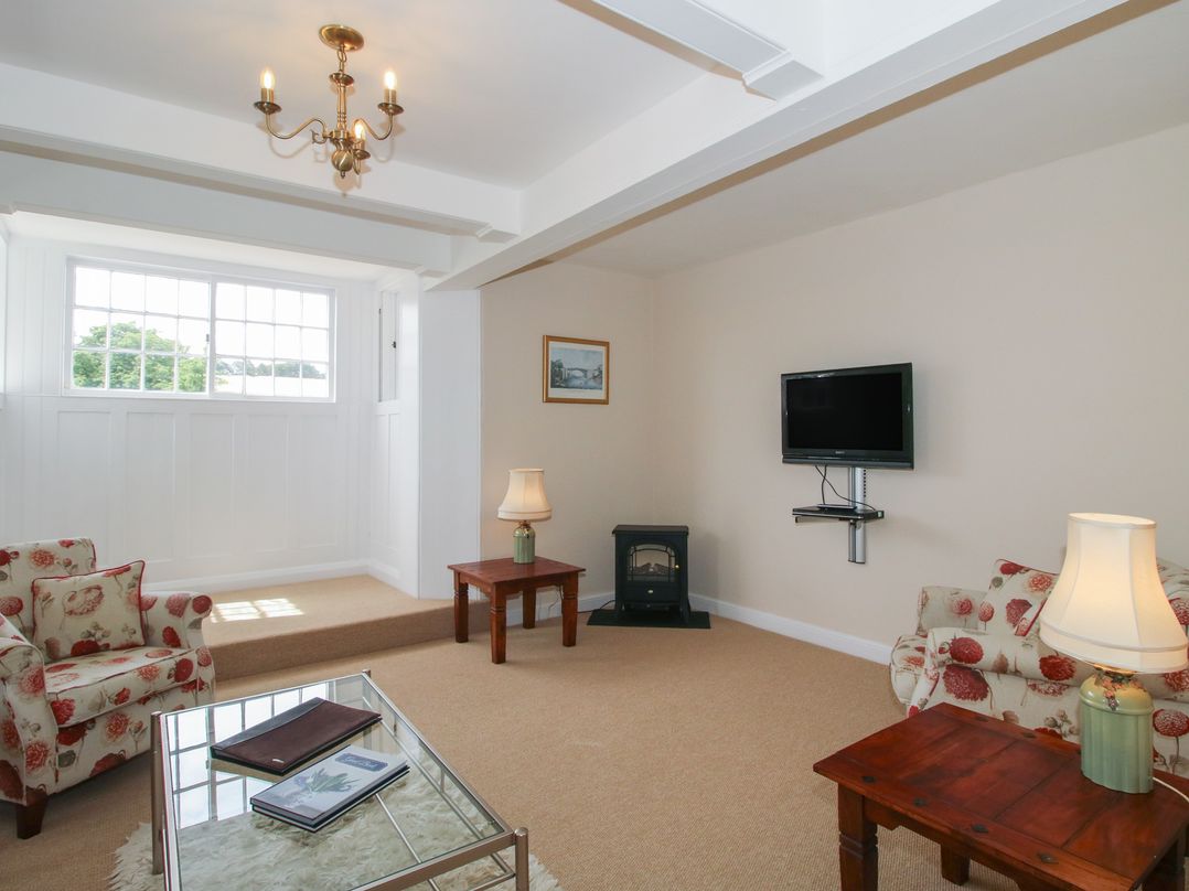 A living room with a TV and sofa at The Old Nursery Bourton near Much Wenlock