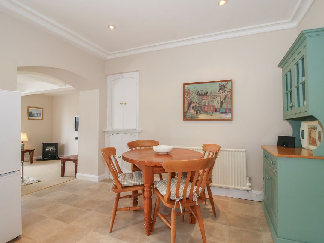 A kitchen with a dining table and chairs at The Old Nursery in Bourton near Much Wenlock