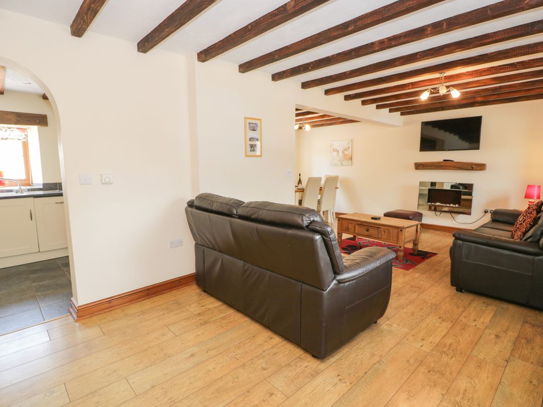 A living room with a coffee table and sofas at Stabal-y-Gwedd in Dolwen near Abergele