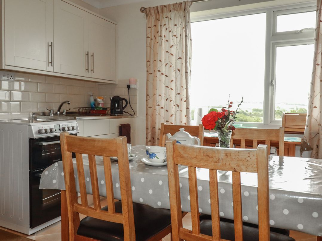 A kitchen with a table and chairs at Little Lanes in Boscastle