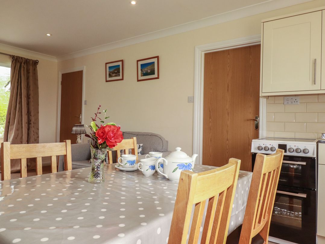 A dining room with a table and chairs at Little Lanes in Boscastle