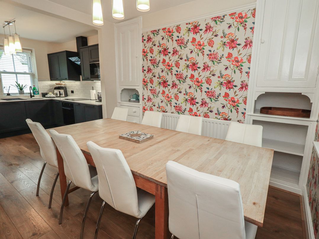A dining room with a large table and chairs at Newby Bridge House in Newby Bridge