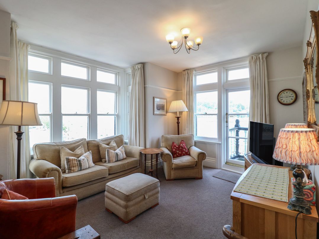 A living room with seating and a television at 2 York House in Dartmouth