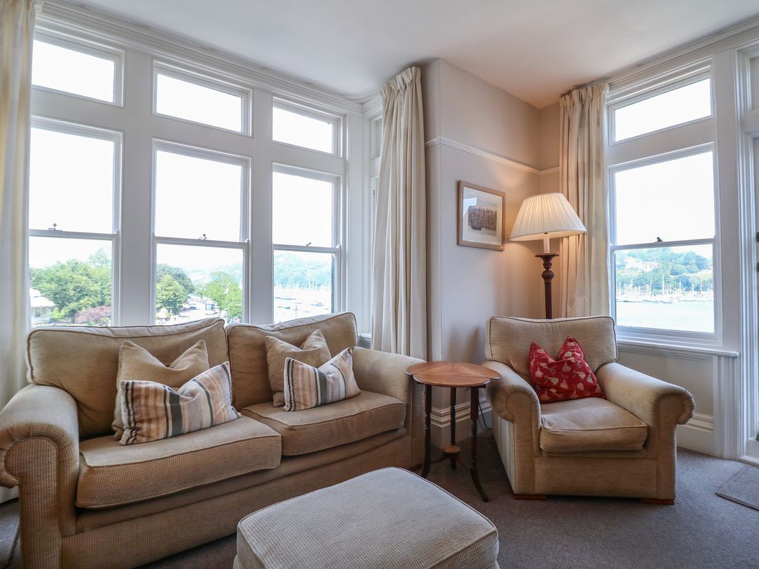 A living room with a sofa and armchair at 2 York House in Dartmouth