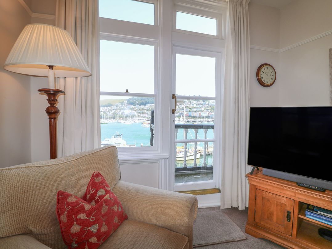 A living room with a window view and a sofa at 2 York House in Dartmouth