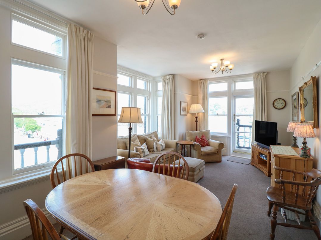 A living room with a dining area and sofa at 2 York House in Dartmouth