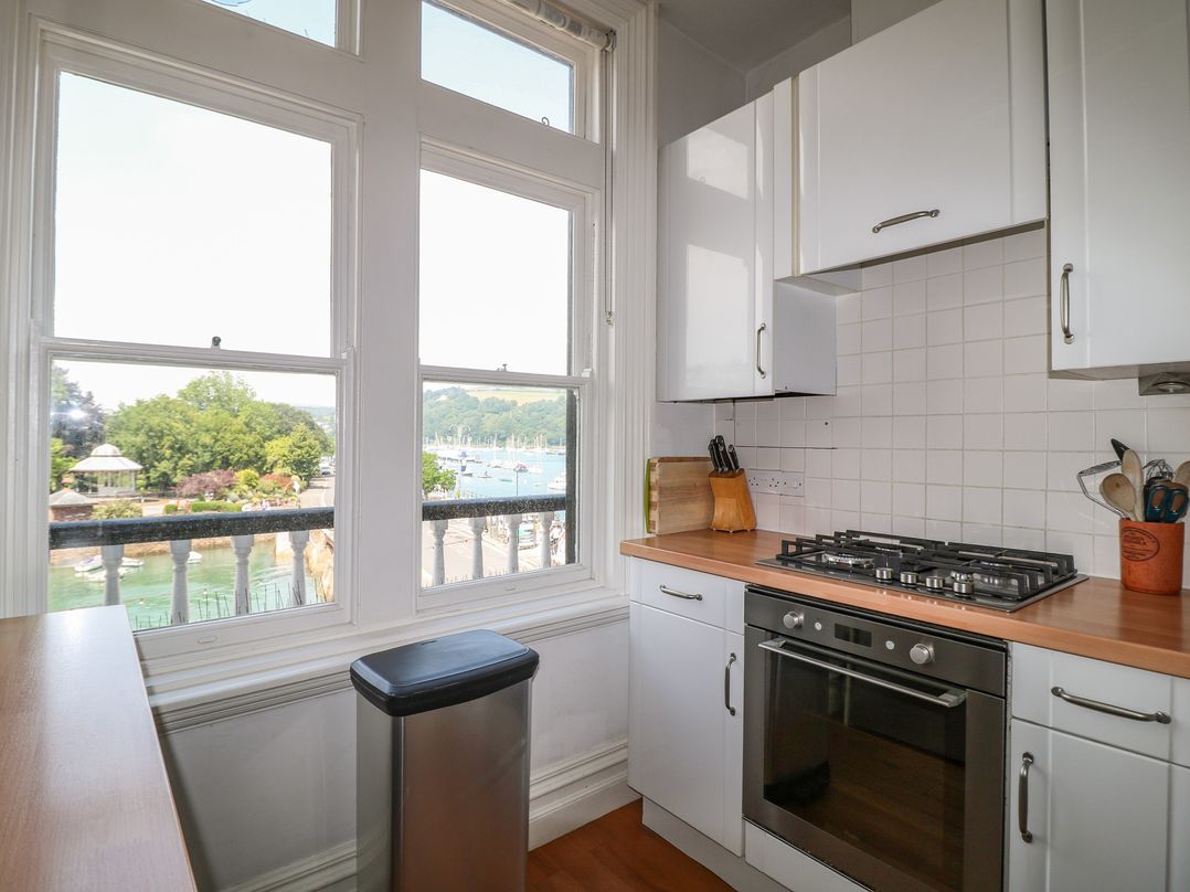 A kitchen with a gas stove and window view at 2 York House Dartmouth