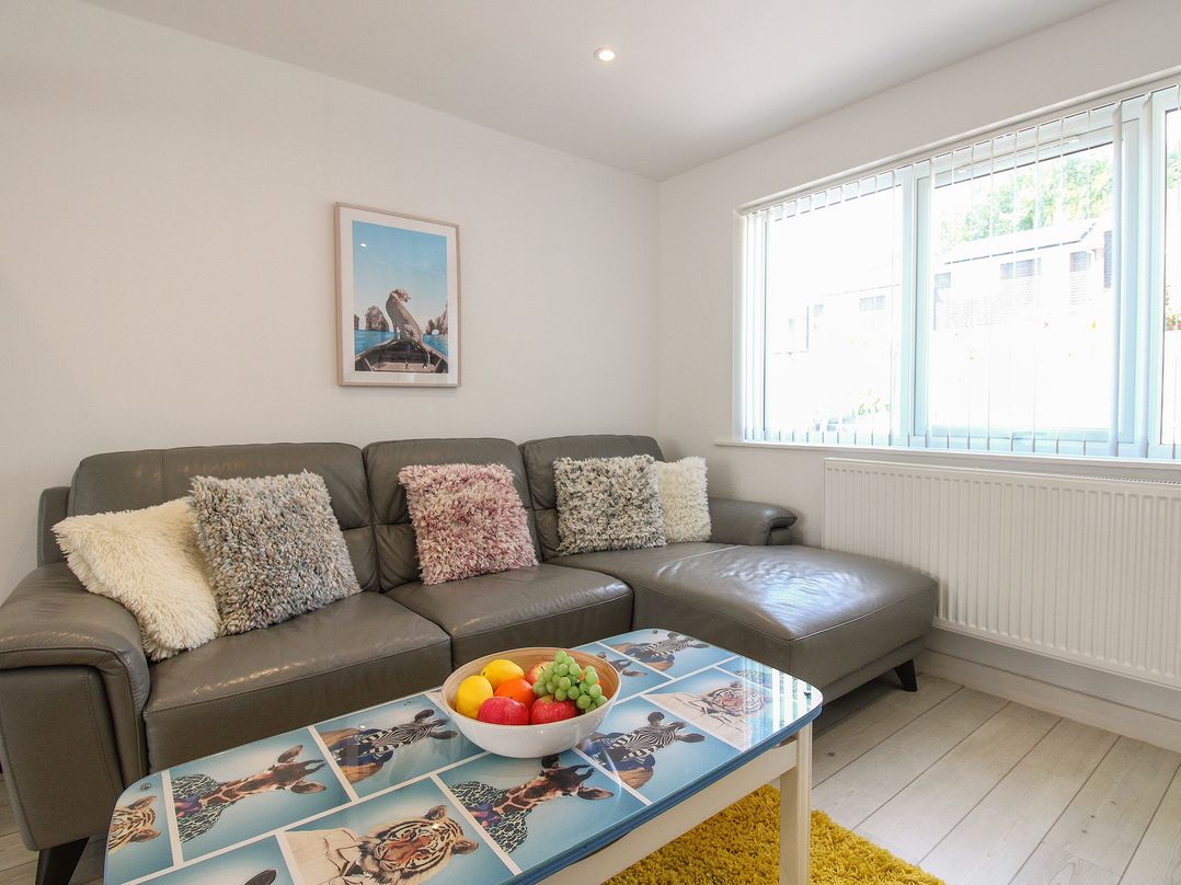 A living room with a sofa and a fruit bowl at Little Starboard in Kingsbridge