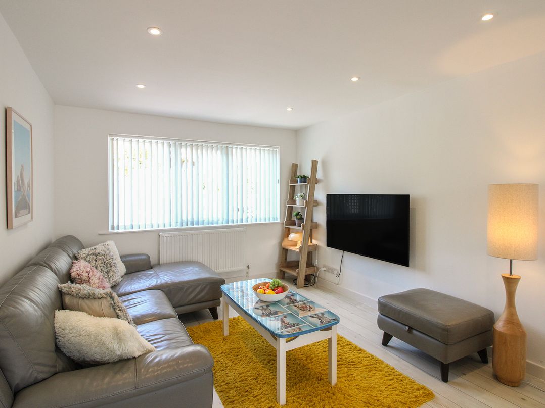 A living room with furniture including a sofa and television at Little Starboard in Kingsbridge