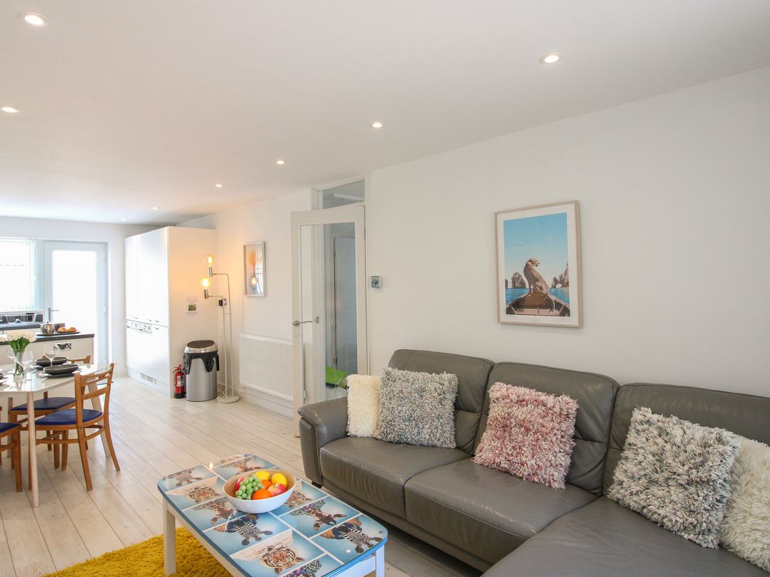 A living room with a sofa and dining table at Little Starboard in Kingsbridge