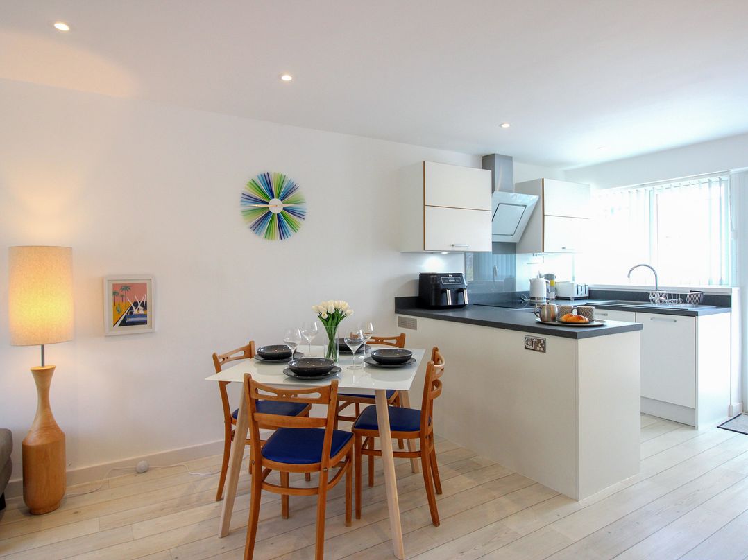 A kitchen with dining table and chairs at Little Starboard in Kingsbridge