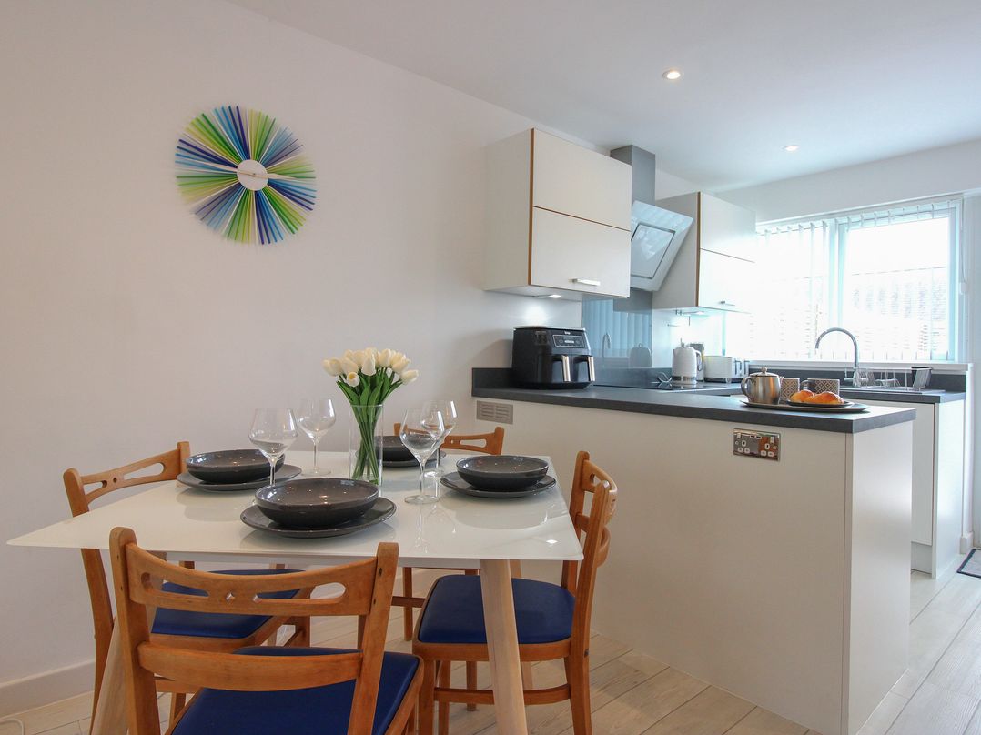 A kitchen with a dining area and a table set at Little Starboard in Kingsbridge