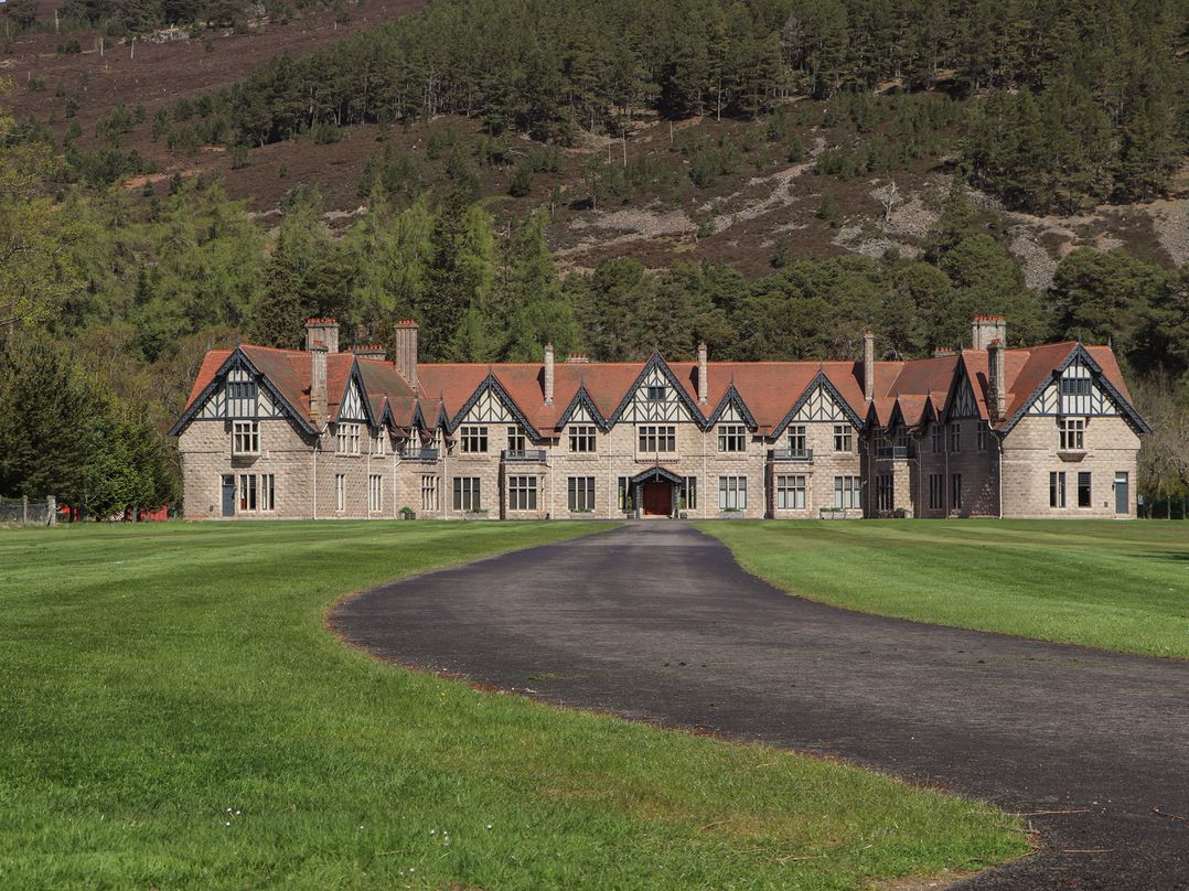 A mansion with a long road in front at Dalvorar - Mar Lodge Estate, Braemar