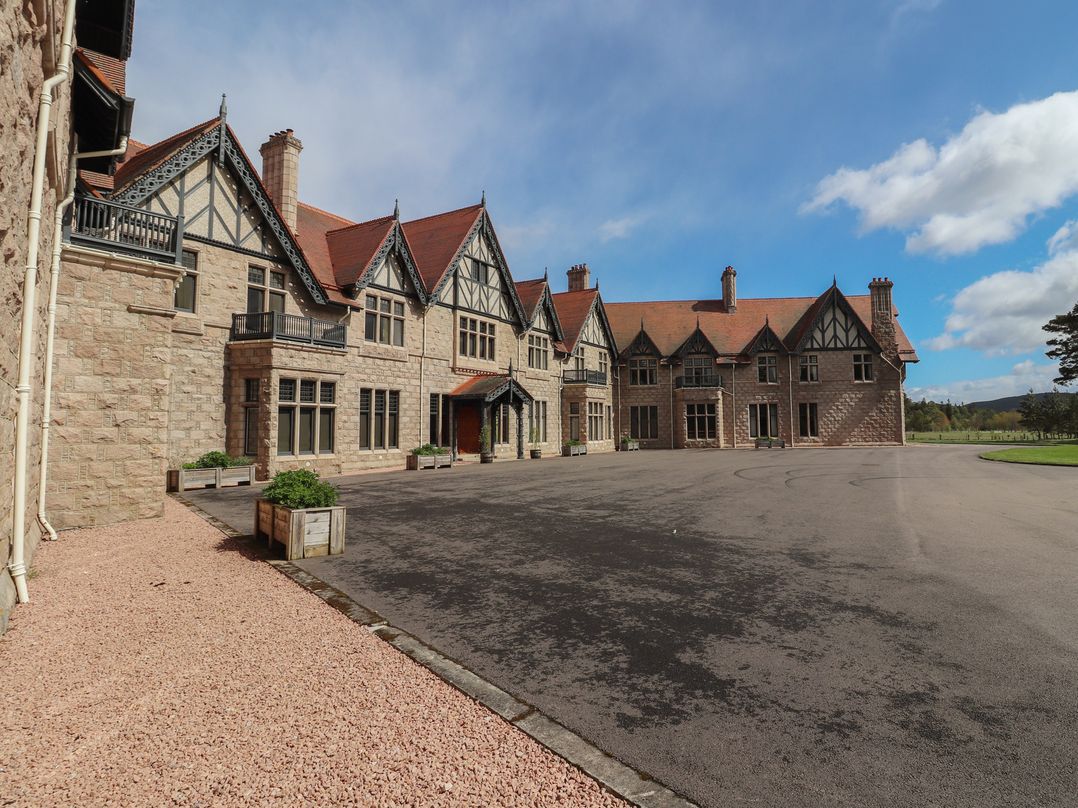 A mansion with an entrance and parking lot at Dalvorar - Mar Lodge Estate, Braemar