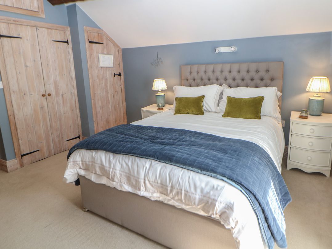 A bedroom with a bed and bedside tables at Green Farm Stables, Hognaston near Carsington Water