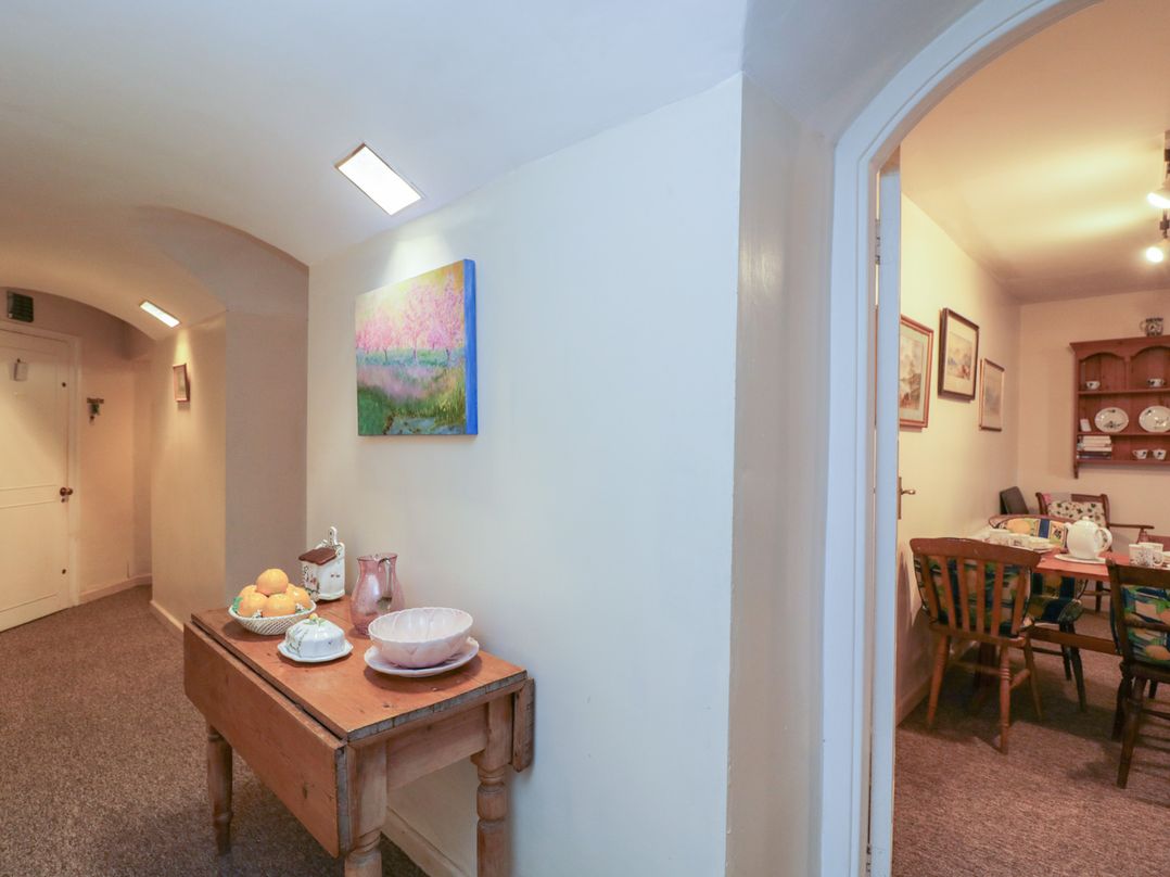 A hallway with a table and chair at Dollar Ward House Basement Cirencester