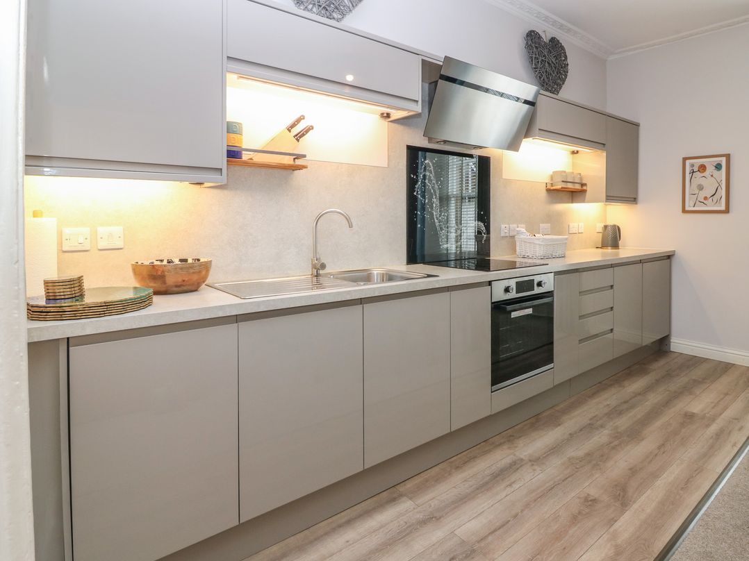 A kitchen with cabinets and appliances at 2 Abbey Row in Kelso
