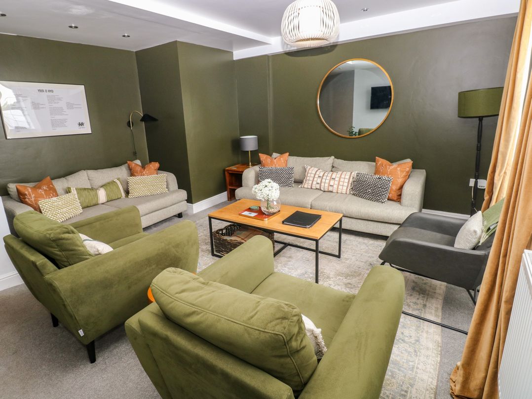 A living room with sofas and a coffee table at Teifi Villa in St Dogmaels