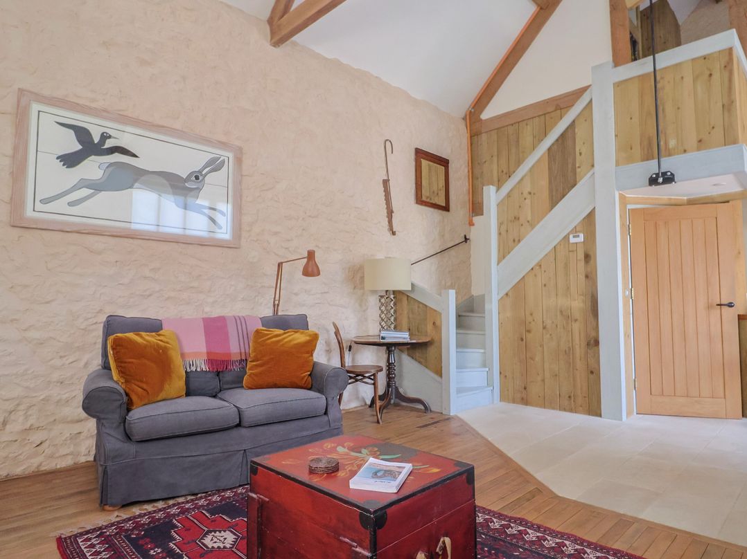A living room with a sofa and coffee table at The Stone Barn in Bridport