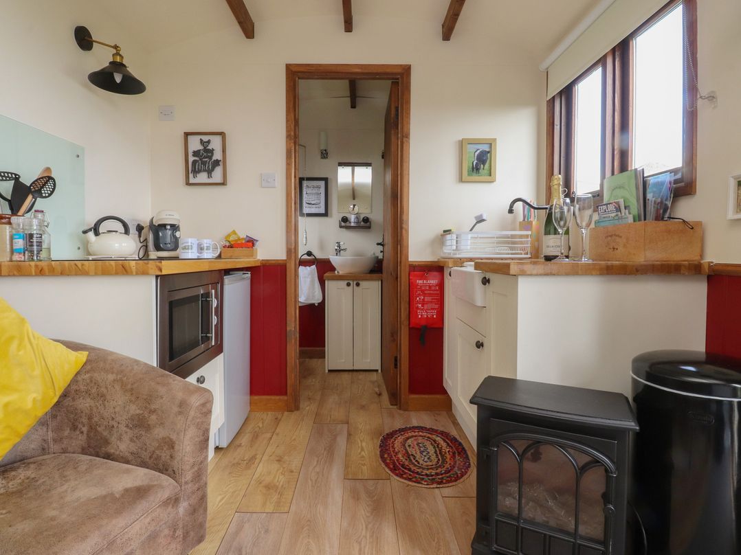 A kitchen with wooden countertop and sink at The Herdsman Luxury Shepherds Hut Barnoldswick