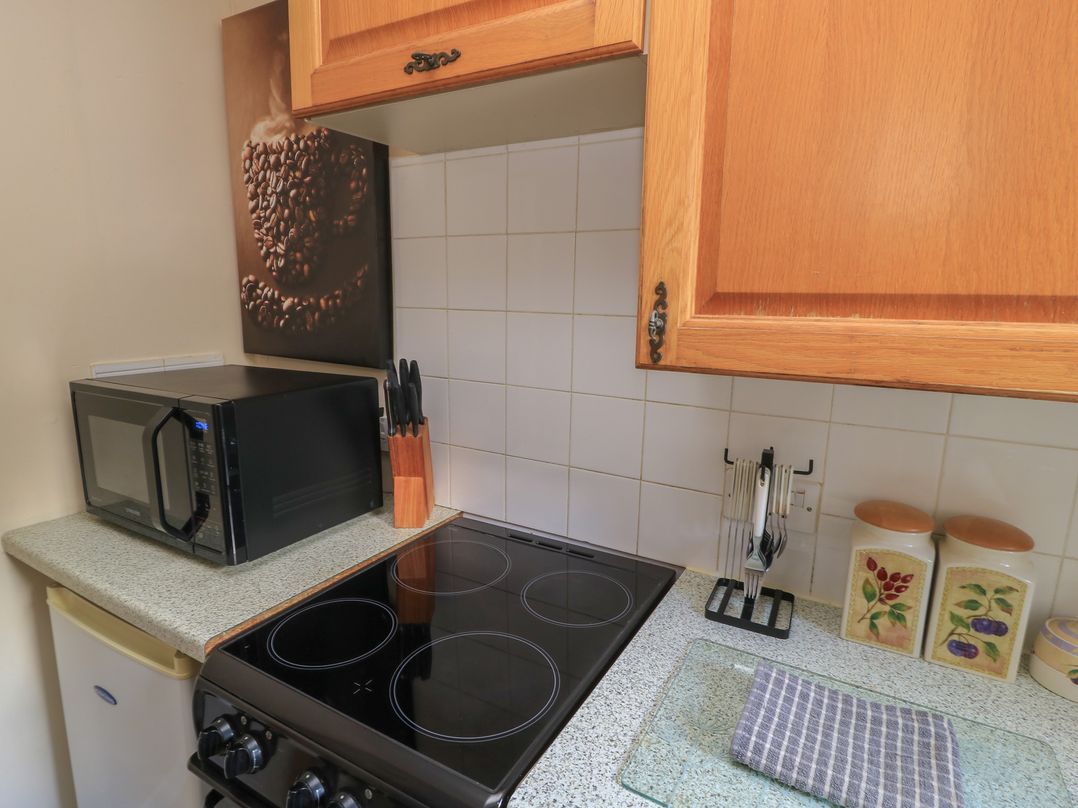 A kitchen with a stove and microwave at Ryecross Farm Cottage in Shaftesbury