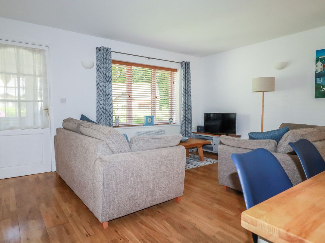 A living room with a sofa and television at Lilyvale in Davidstow near Camelford