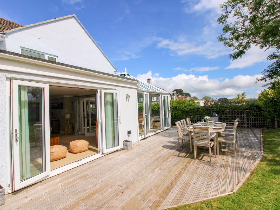 An outdoor patio with a table and chairs at Welsummer in Salcombe