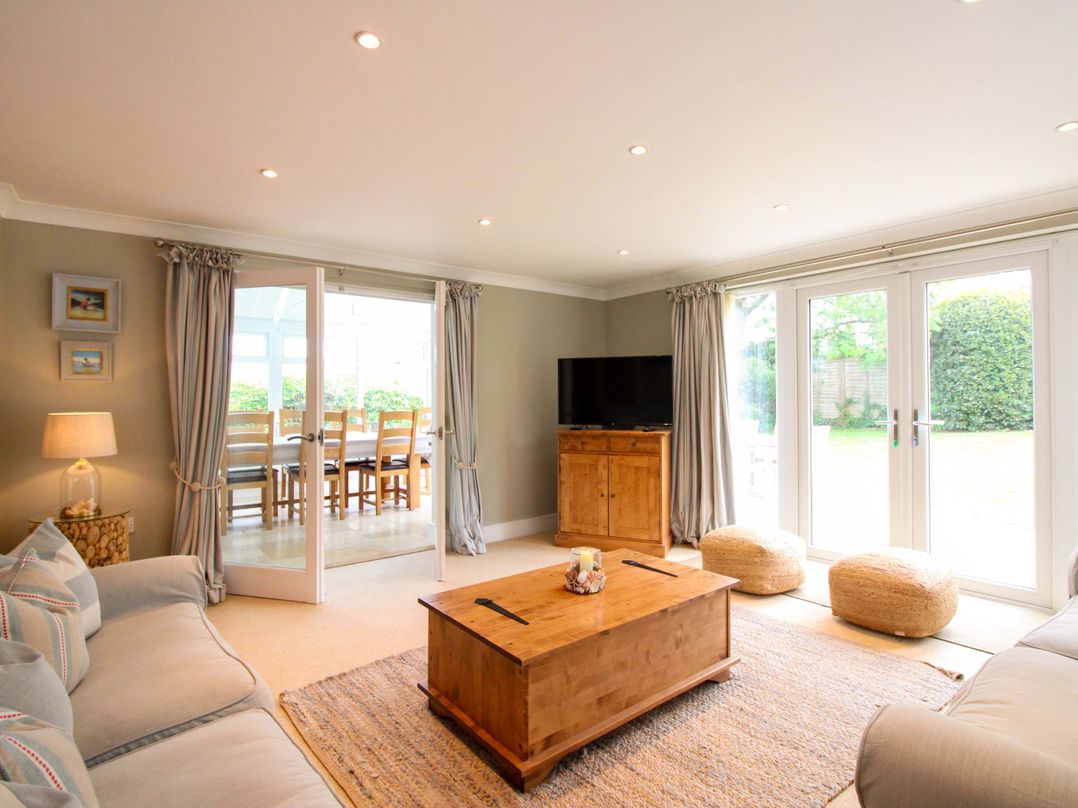 A living room with a coffee table and TV at Welsummer in Salcombe