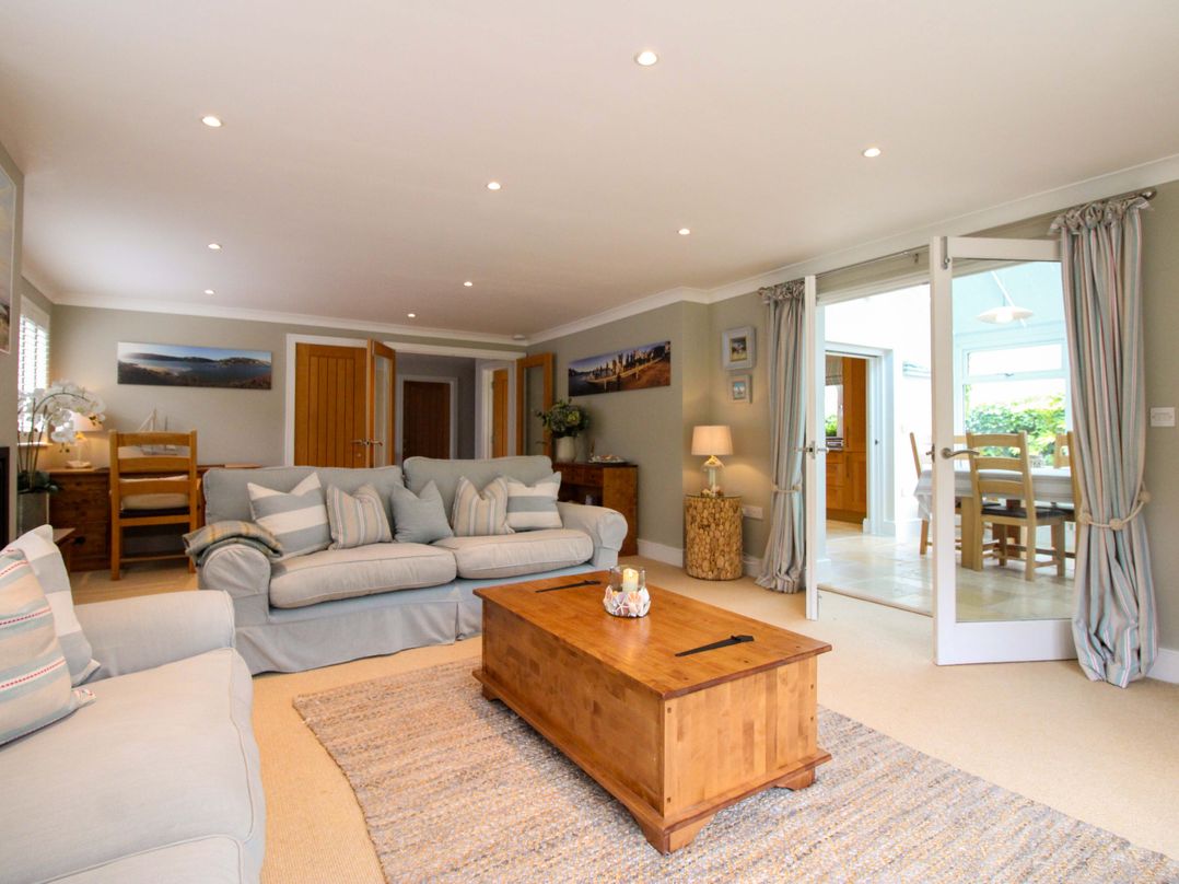 A living room with a sofa and coffee table at Welsummer in Salcombe