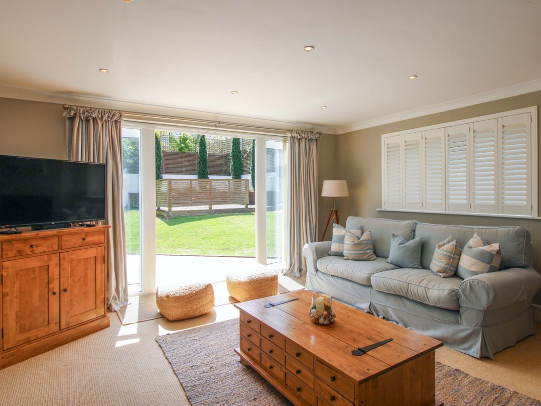 A living room with a sofa and coffee table at Welsummer in Salcombe