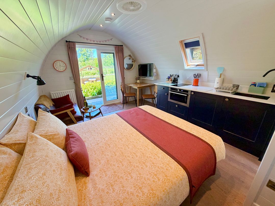 A bedroom with a kitchen area and dining table at No Deer in Ashbourne