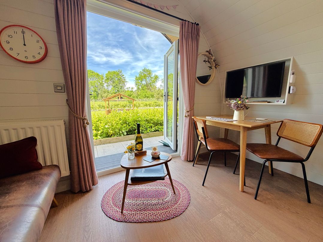 A living room with a table and chairs at No Deer in Ashbourne