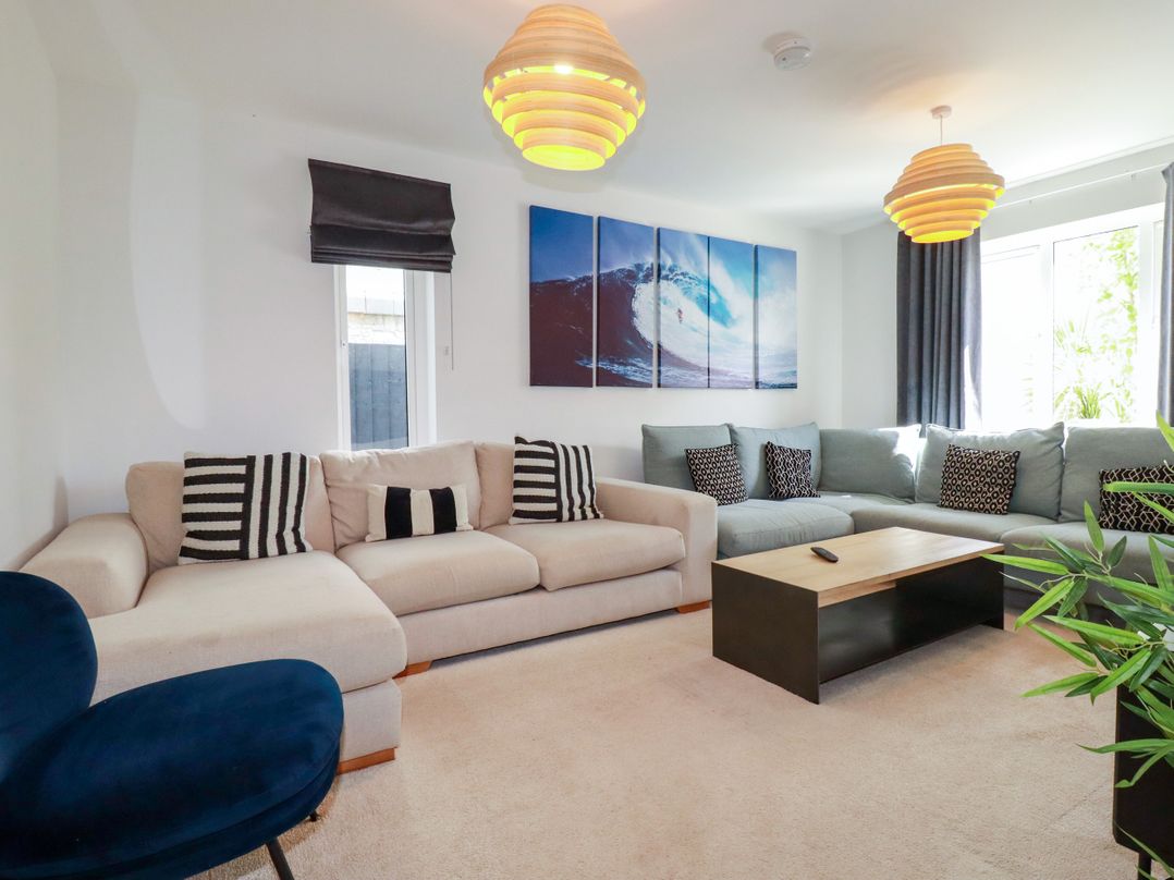 A living room with sofa and coffee table at Lavender House in Crantock