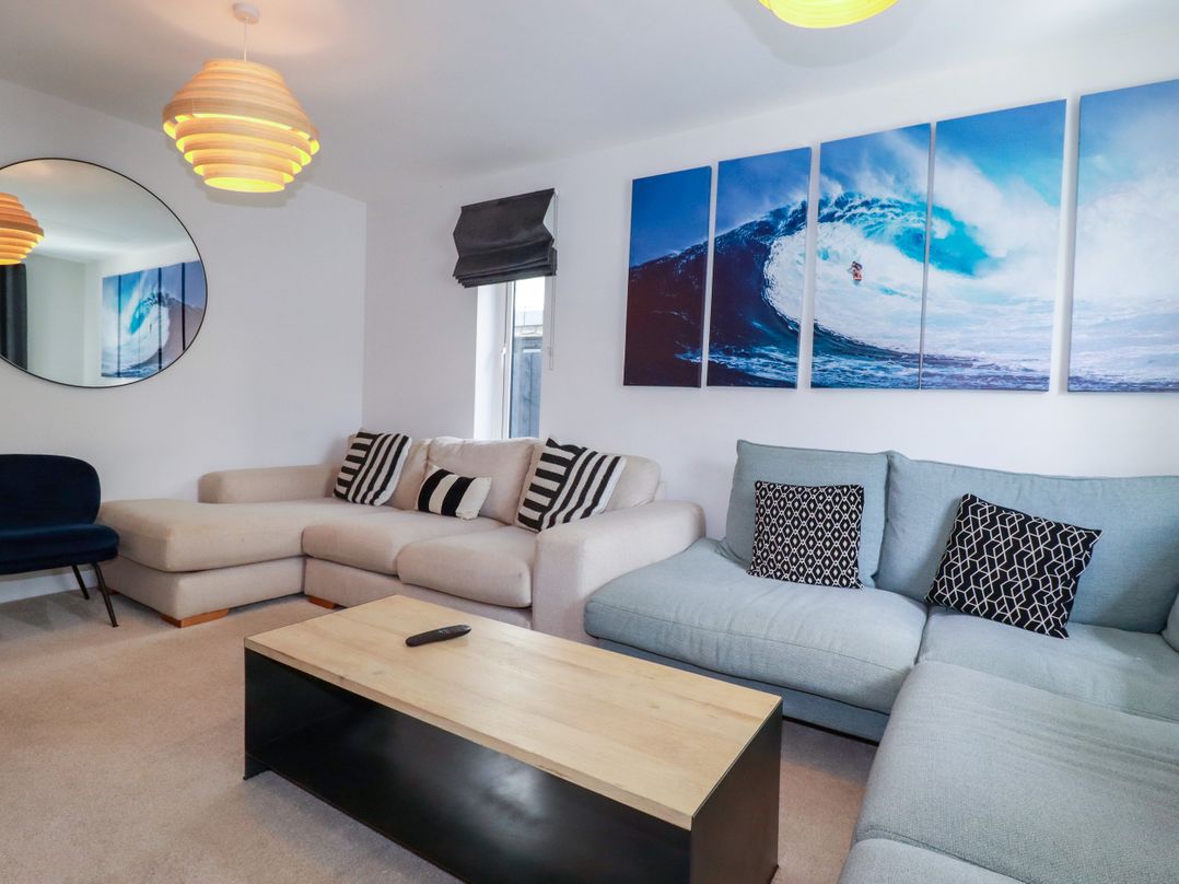 A living room with a sofa and coffee table at Lavender House in Crantock