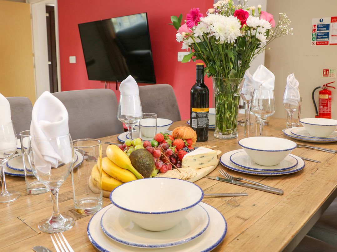 A dining table set with plates and fruit at Hartington in Darley Moor near Two Dales
