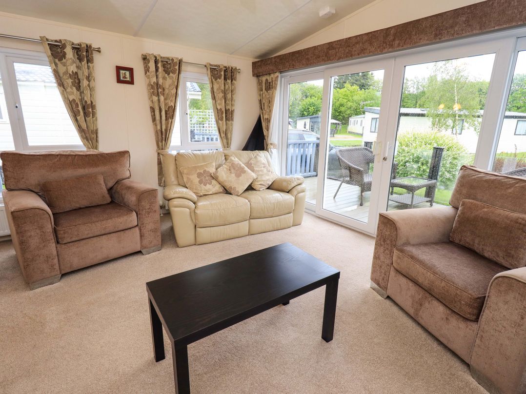 A living room with sofas and a coffee table at 41, Grandma's Cottage near Carnforth