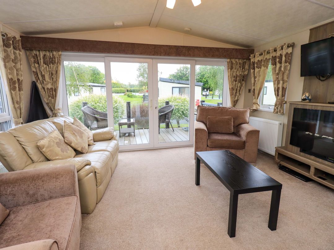 A living room with a sofa and armchair at 41, Grandma's Cottage near South Lakeland Leisure Village Carnforth