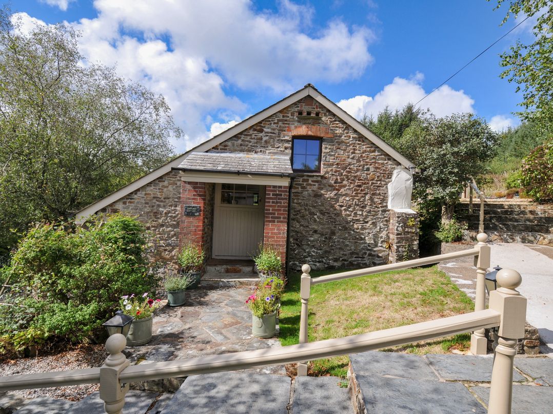 A house entrance with plants and pathway at Shipload Cottage Hartland