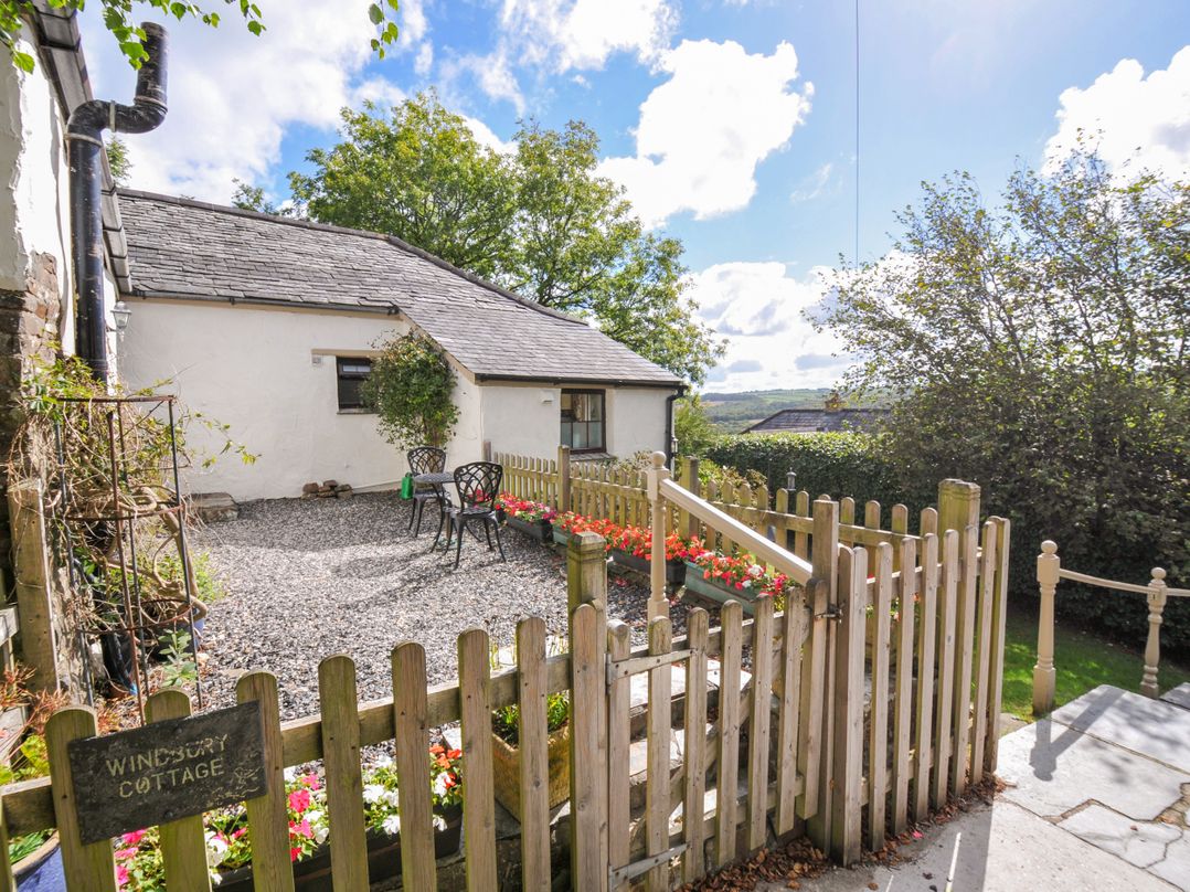 A garden with seating area and flowers at Windbury Cottage Hartland