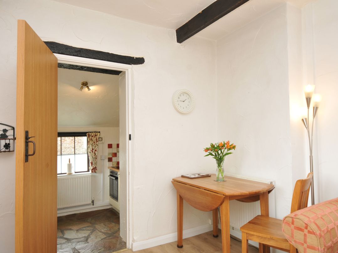 A dining area with a table and chairs at Barley Cottage in Hartland