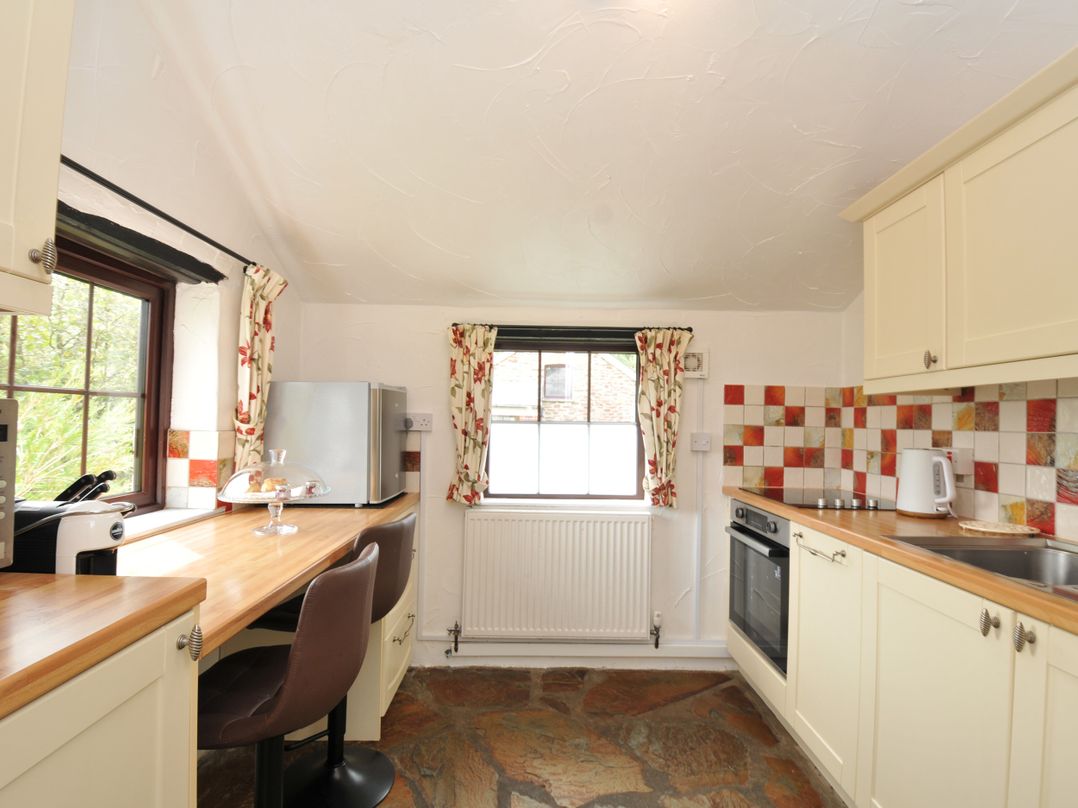 A kitchen with a refrigerator and oven at Barley Cottage in Hartland
