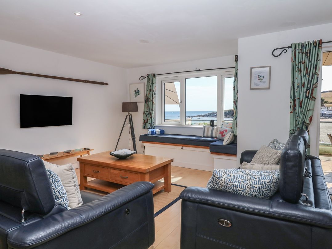 A living room with a coffee table and a television at 4 Burgh Island Causeway in Bigbury