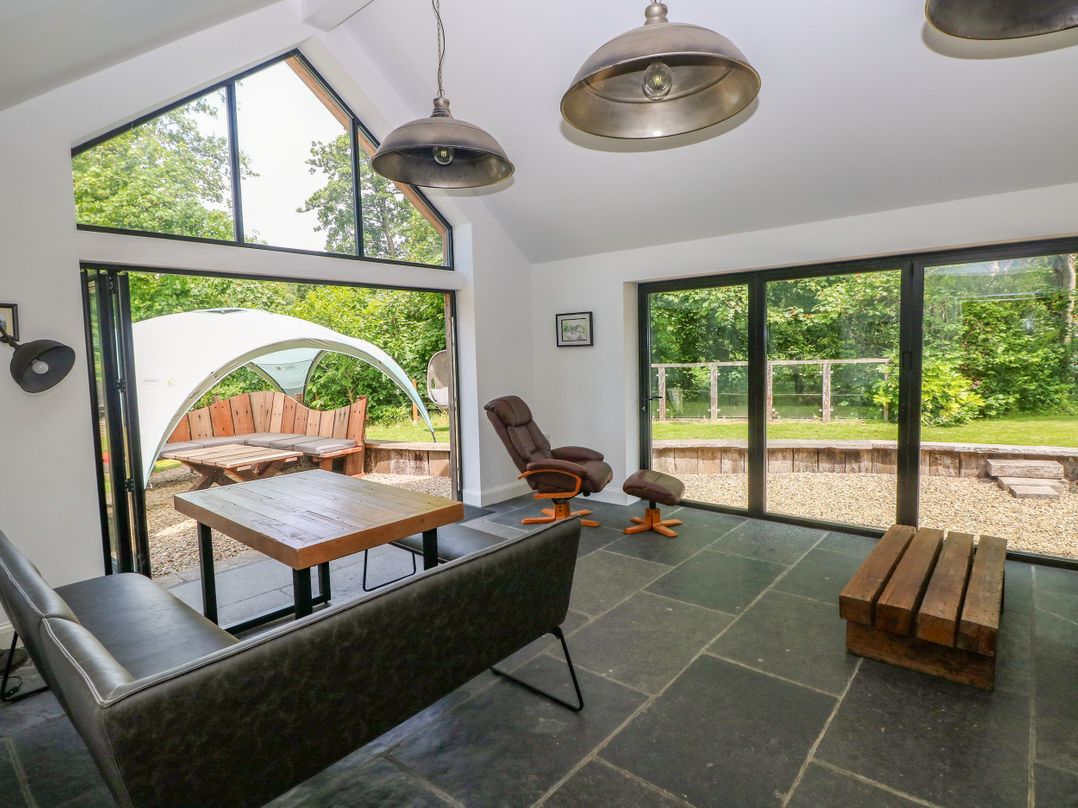 A living room with a table and sofa at Glas y Dorlan in Nevern near Newport, Pembrokeshire