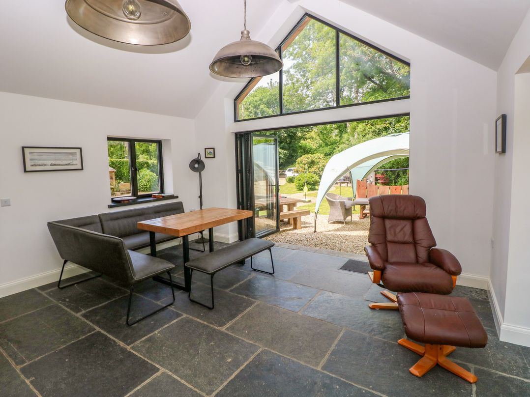 A dining room with a table and chairs at Glas y Dorlan Nevern near Newport, Pembrokeshire